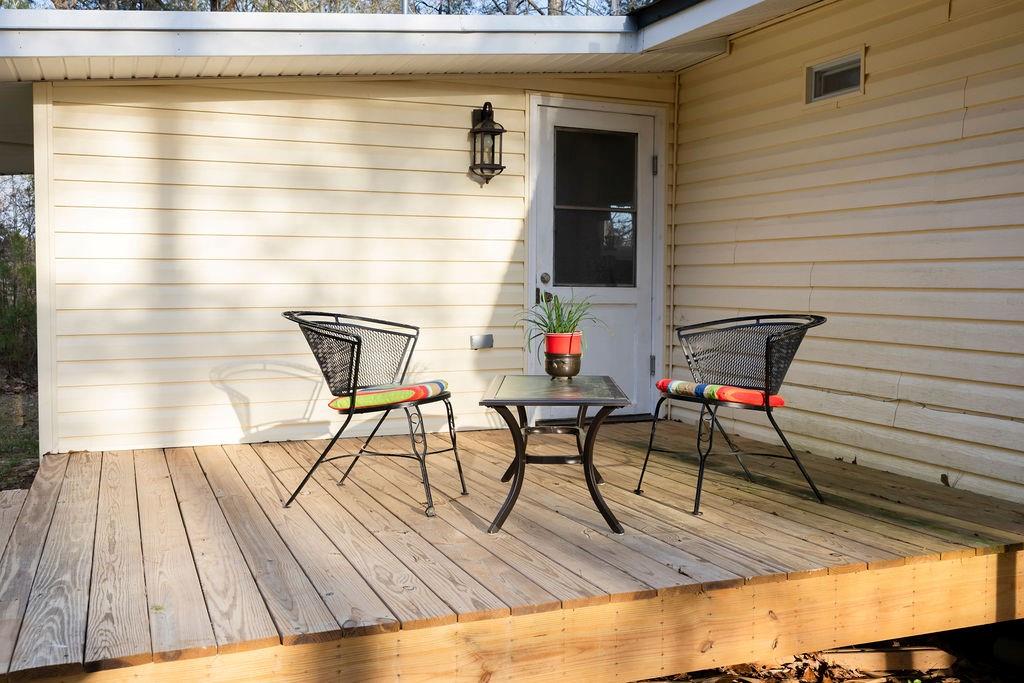 107 South Gates Road Pine Mountain, GA 31822 - Photo 15 of 18 a roof deck with table and chairs and wooden floor