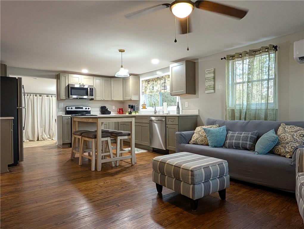 107 South Gates Road Pine Mountain, GA 31822 - Photo 3 of 18 a living room with stainless steel appliances kitchen island granite countertop wooden floor a couch and a window