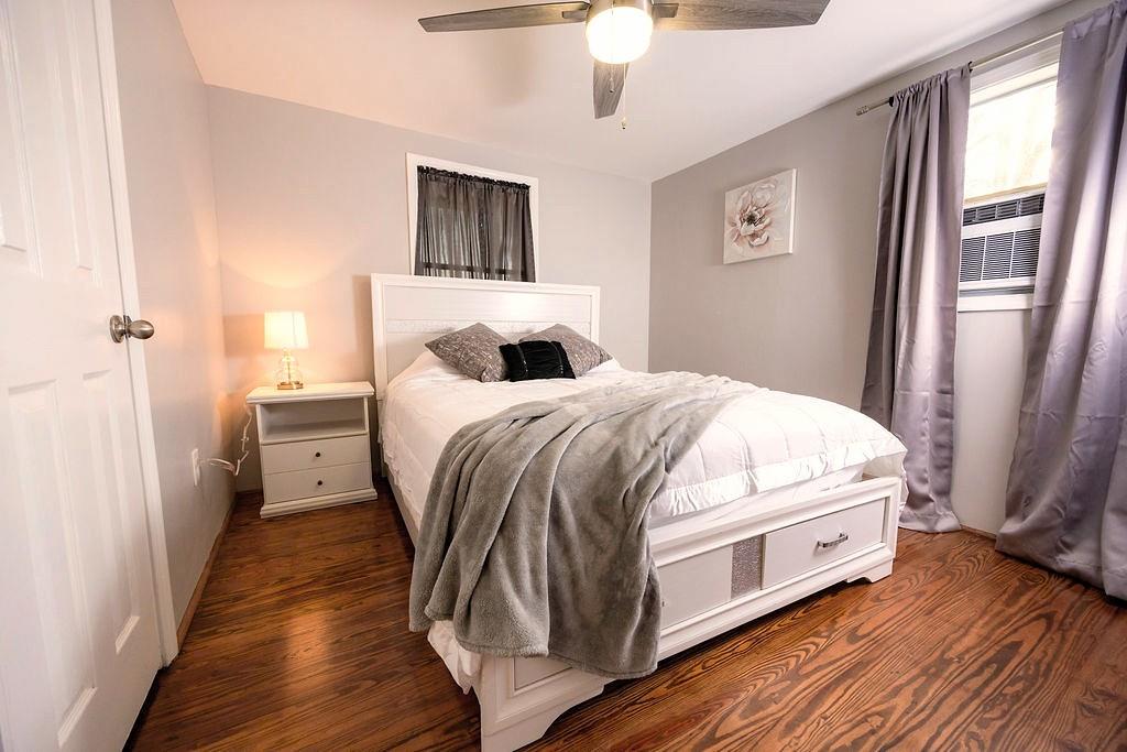 107 South Gates Road Pine Mountain, GA 31822 - Photo 10 of 18 a bedroom with a bed and a large mirror with wooden floor
