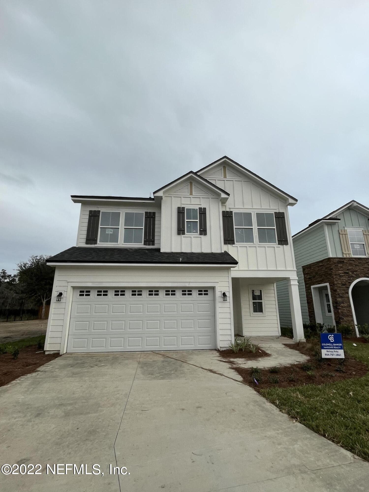 3051 Orange Picker Road Jacksonville, FL 32223 - Photo 1 of 7 a view of a house with a yard and garage