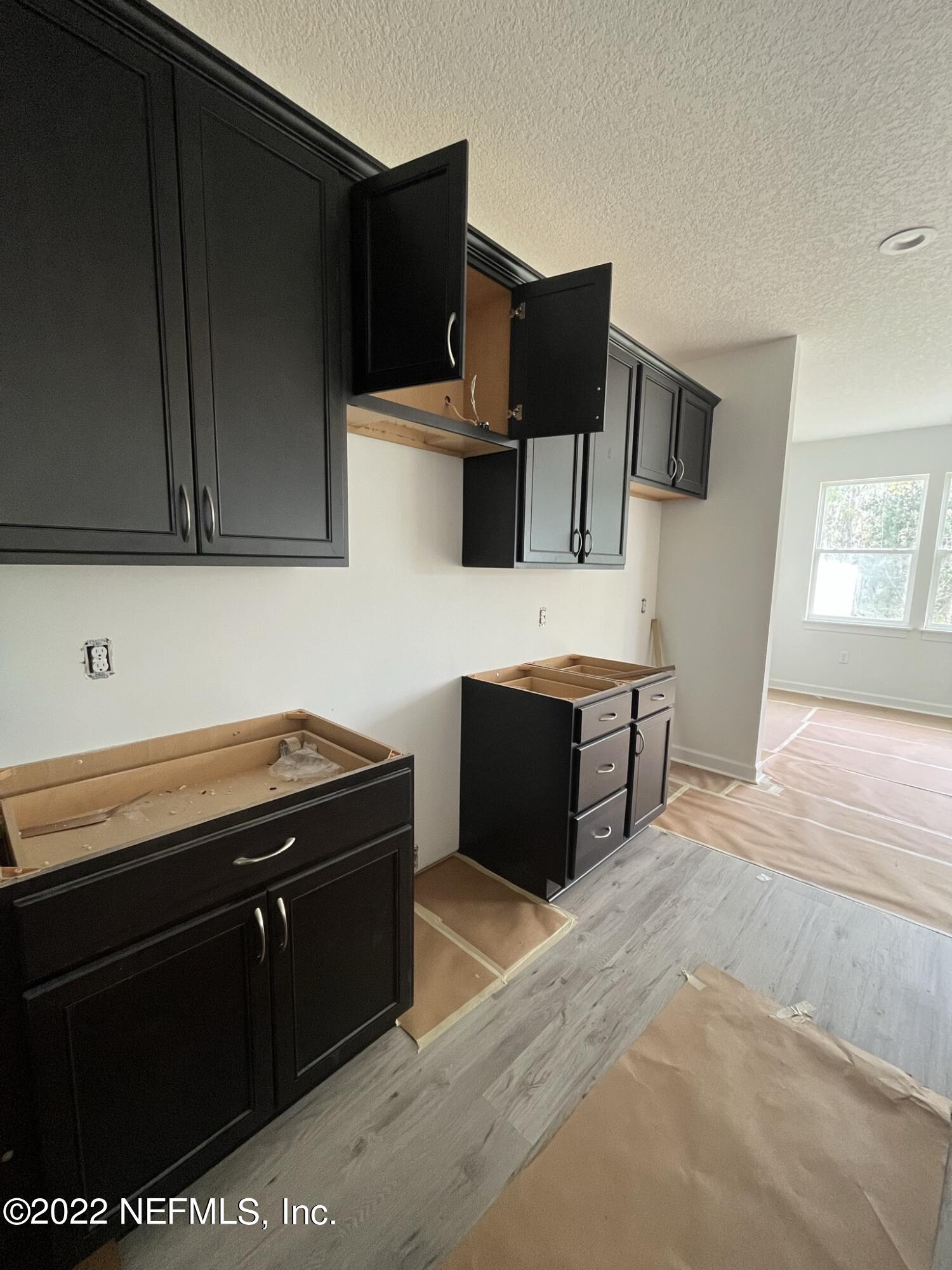 3051 Orange Picker Road Jacksonville, FL 32223 - Photo 2 of 7 a kitchen with stainless steel appliances wooden cabinets and a sink