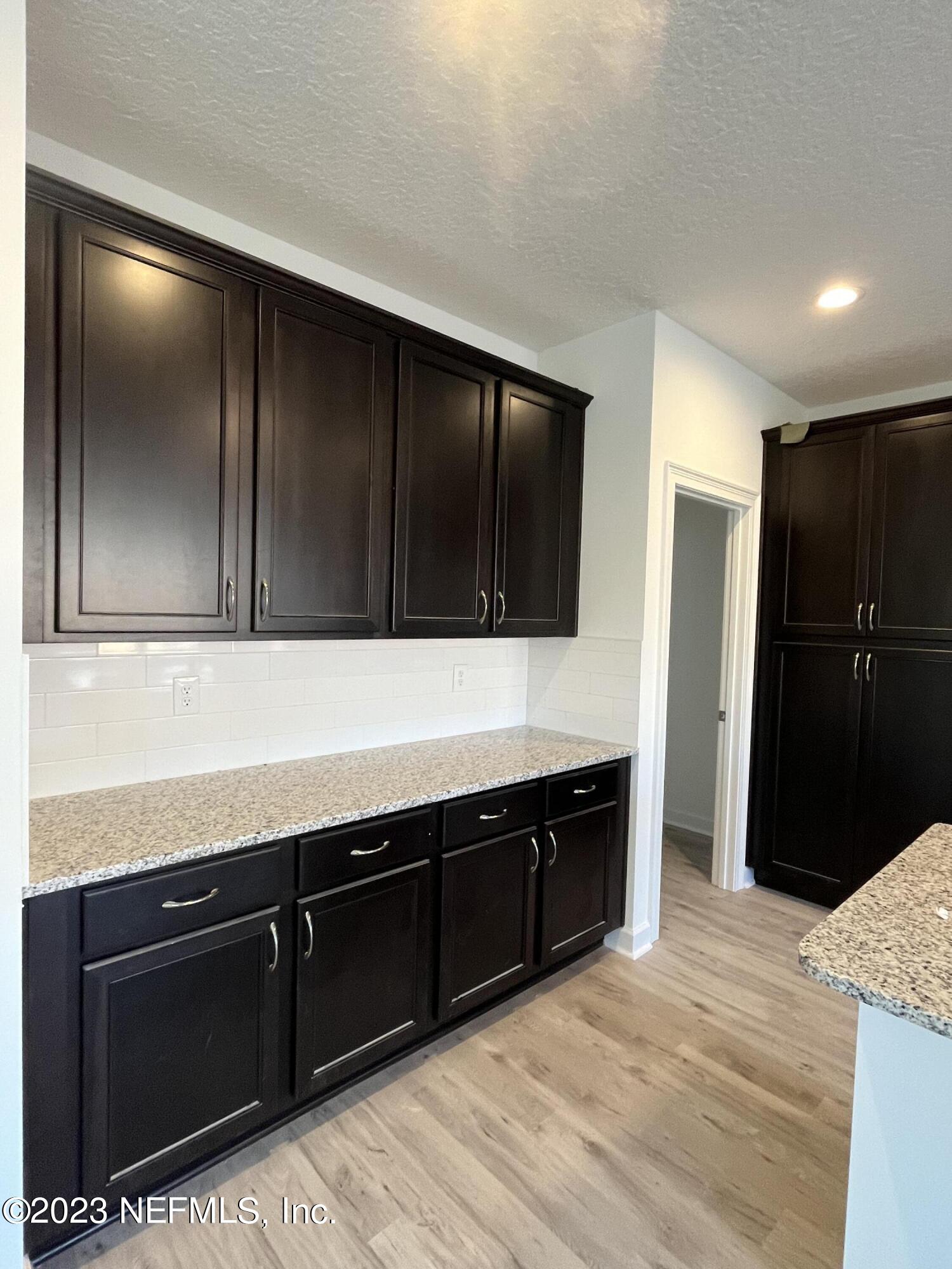 3051 Orange Picker Road Jacksonville, FL 32223 - Photo 6 of 7 a kitchen with a refrigerator and a sink