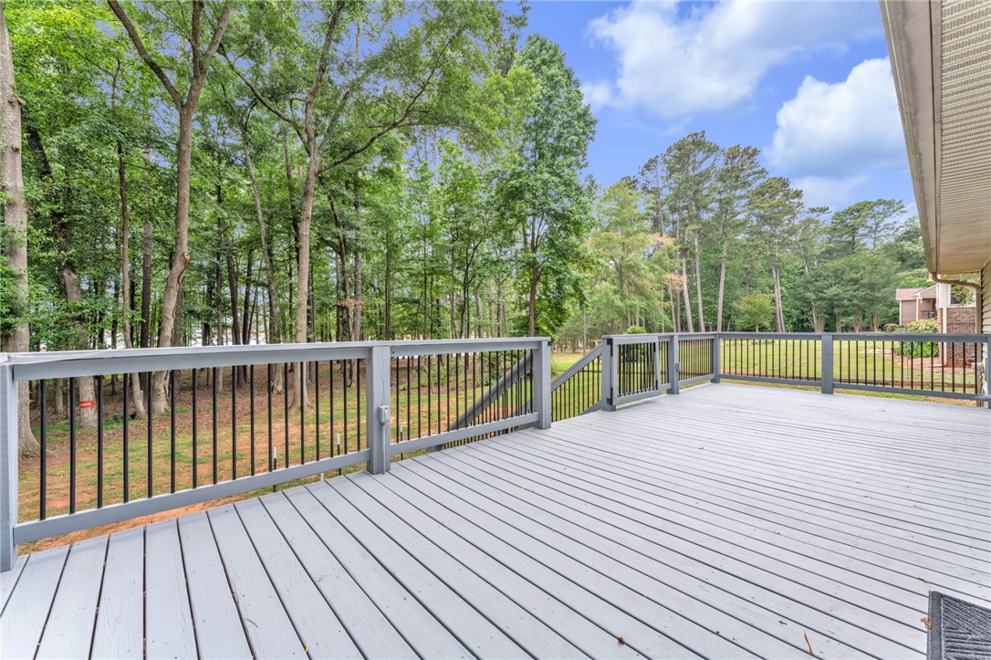 4416 Denver Cove Road Anderson, SC 29625 - Photo 22 of 31 A spacious outdoor deck offers peaceful views of the surrounding natural landscape and mature trees.
