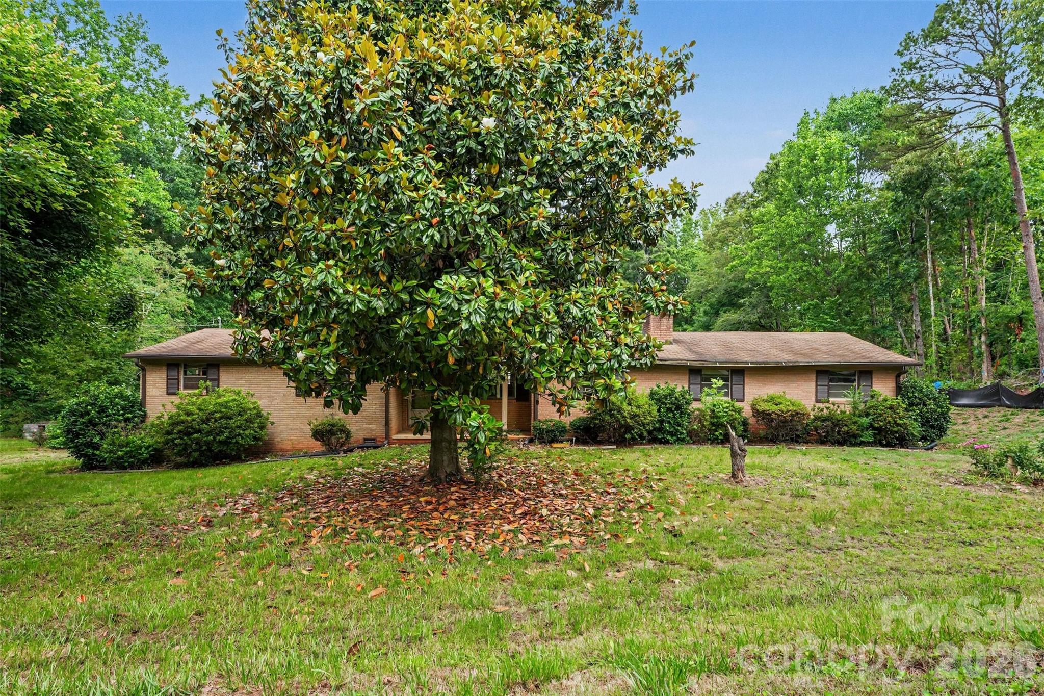 2871 Loviee Road Lincolnton, NC 28092 - Photo 13 of 14 a view of a backyard with a garden and trees