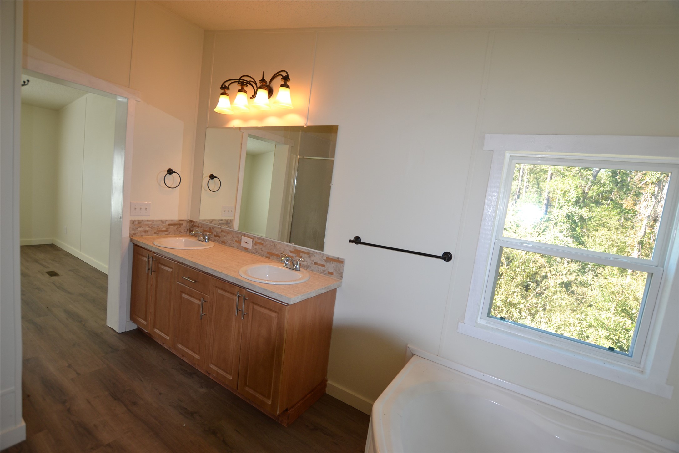 13402 U.S. Highway 190 Onalaska, TX 77360 - Photo 13 of 16 a bathroom with a sink and a mirror