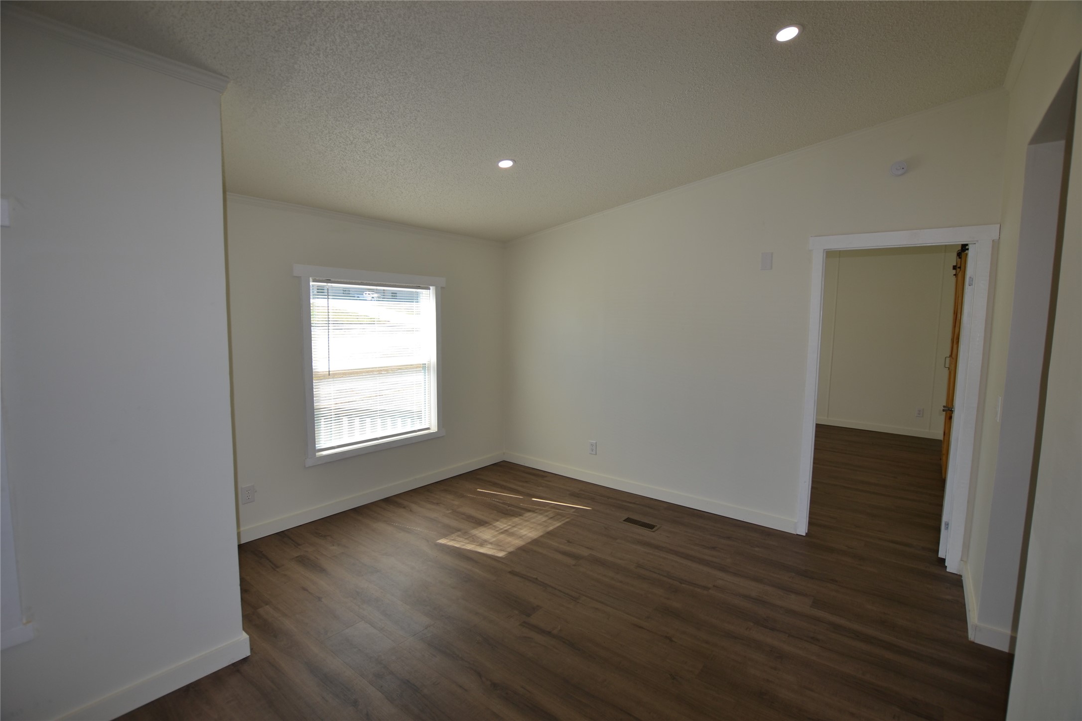 13402 U.S. Highway 190 Onalaska, TX 77360 - Photo 6 of 16 an empty room with wooden floor and windows