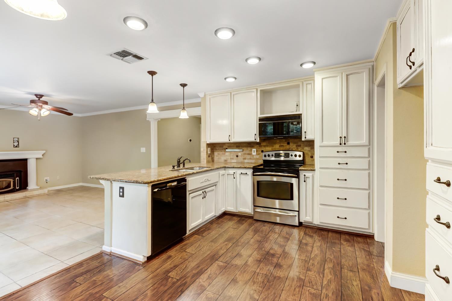 4683 Abrijo Road Cameron Park, CA 95682 - Photo 12 of 53 a kitchen with granite countertop a stove top oven and cabinets