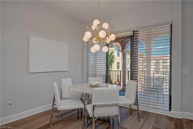 a kitchen with stainless steel appliances granite countertop a refrigerator a stove and a sink with wooden floor