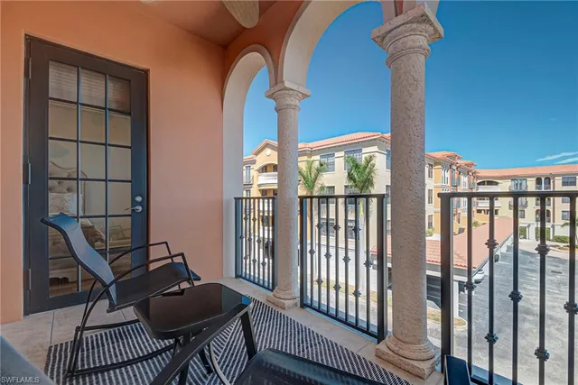 a living room with furniture a dining table and chairs with wooden floor