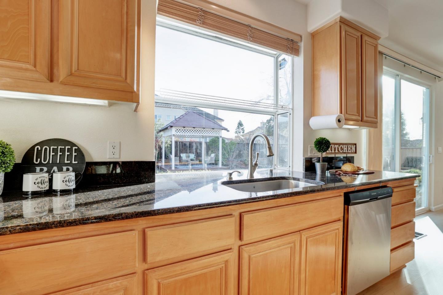 313 Lower Vintners Circle Fremont, CA 94539 - Photo 19 of 50 a kitchen with granite countertop a sink and a window