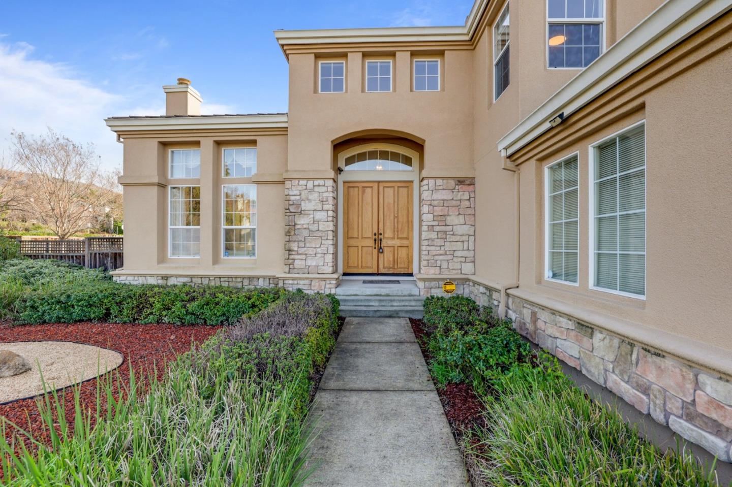 313 Lower Vintners Circle Fremont, CA 94539 - Photo 2 of 50 a front view of a house with a garden