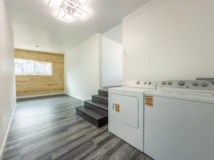 a view of a bedroom with wooden floor
