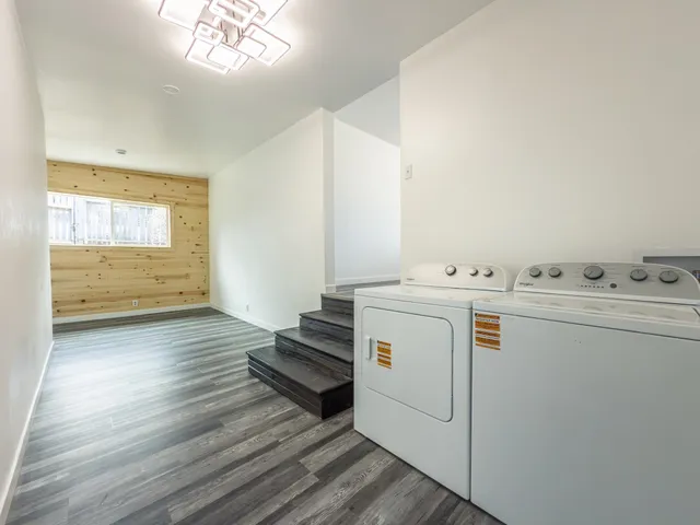 a view of a bedroom with wooden floor