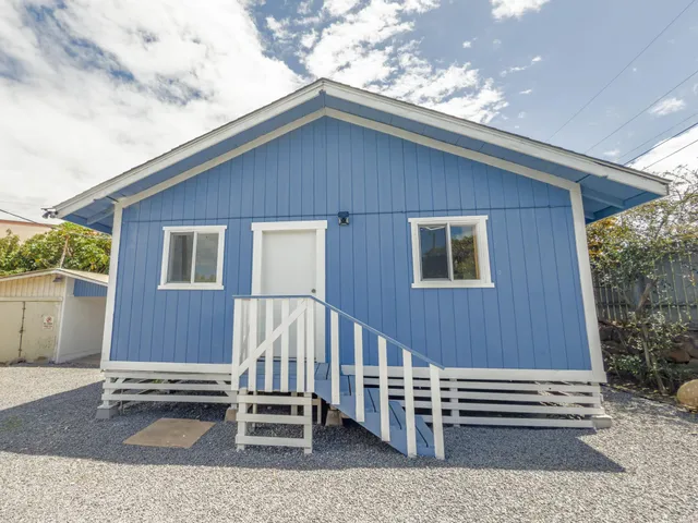 a backyard of a house with a garden and deck
