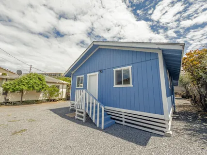 a backyard of a house with a table and chairs