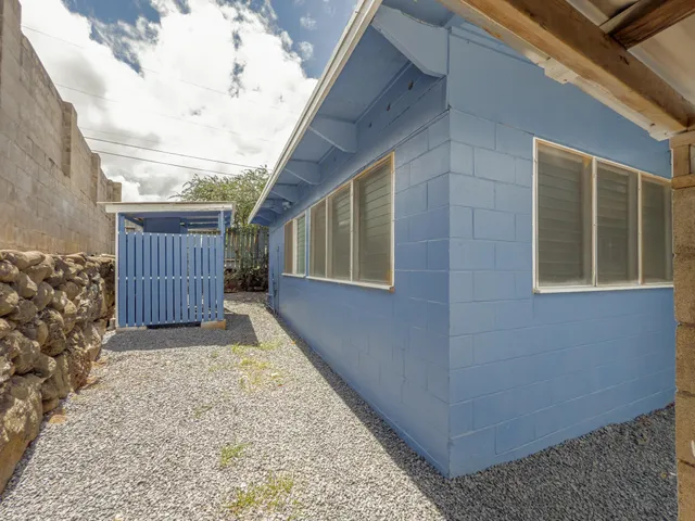 a view of a house with a wooden fence