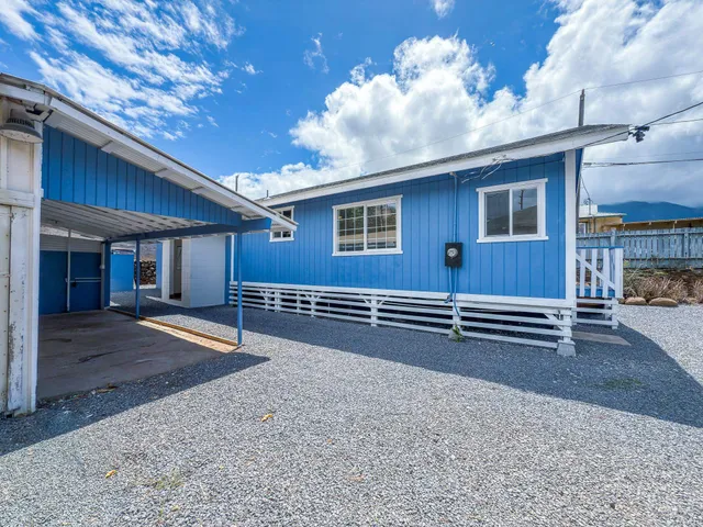 an aerial view of a house with garden space and street view