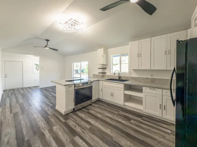 a kitchen with granite countertop a refrigerator and a stove