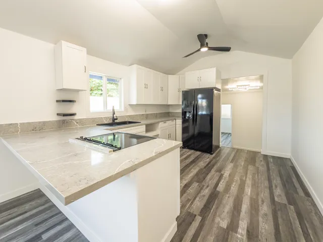 a kitchen that has a sink and a stove in it