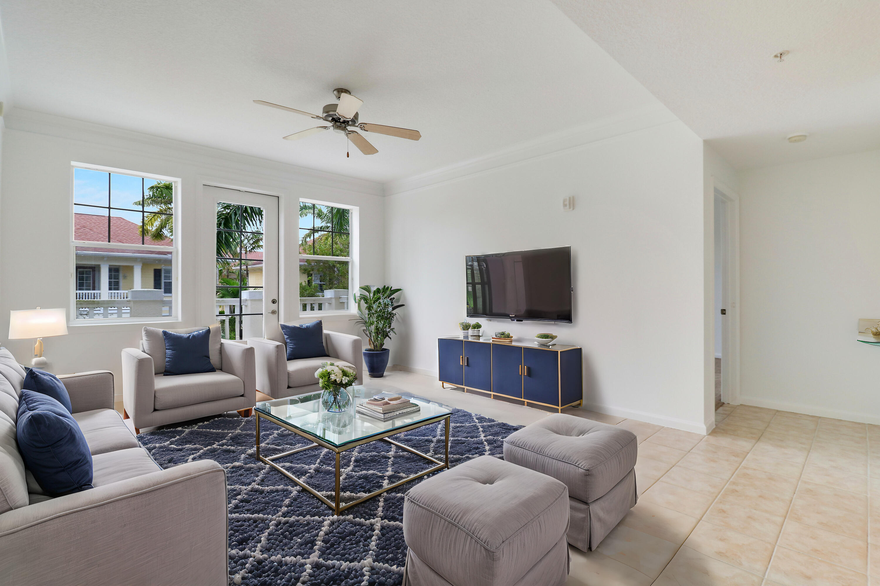 225 Murcia Drive, Unit 307 Jupiter, FL 33458 - Photo 14 of 36 a living room with furniture a flat screen tv and a large window