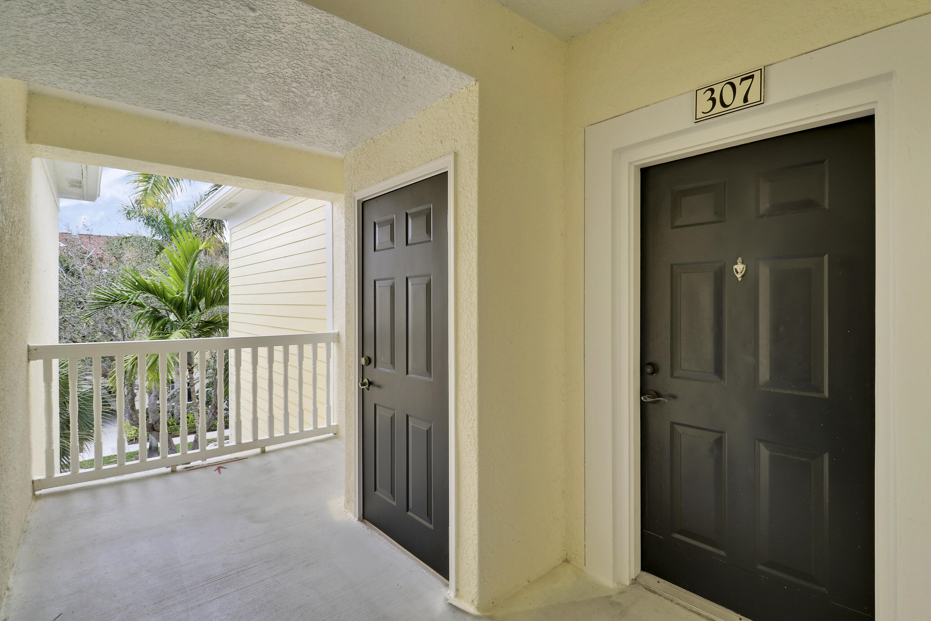 225 Murcia Drive, Unit 307 Jupiter, FL 33458 - Photo 2 of 36 a view of a hallway with wooden floor and windows