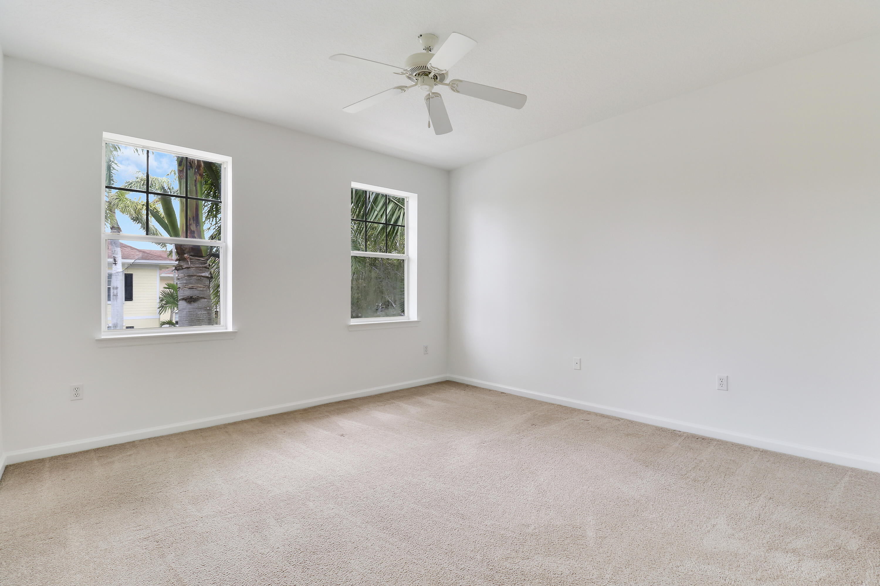 225 Murcia Drive, Unit 307 Jupiter, FL 33458 - Photo 23 of 36 an empty room with windows and fan