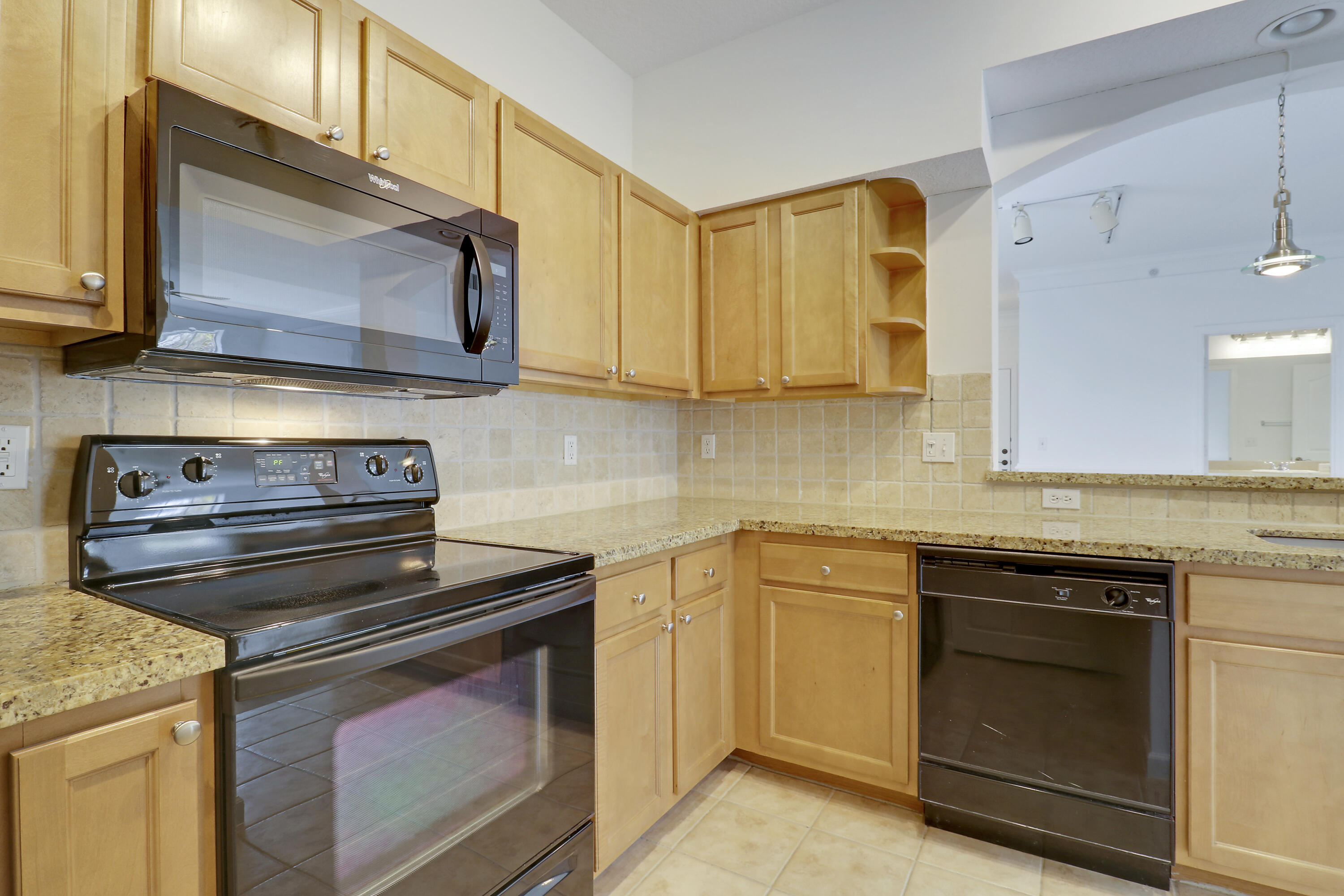 225 Murcia Drive, Unit 307 Jupiter, FL 33458 - Photo 30 of 36 a kitchen with a stove and a microwave