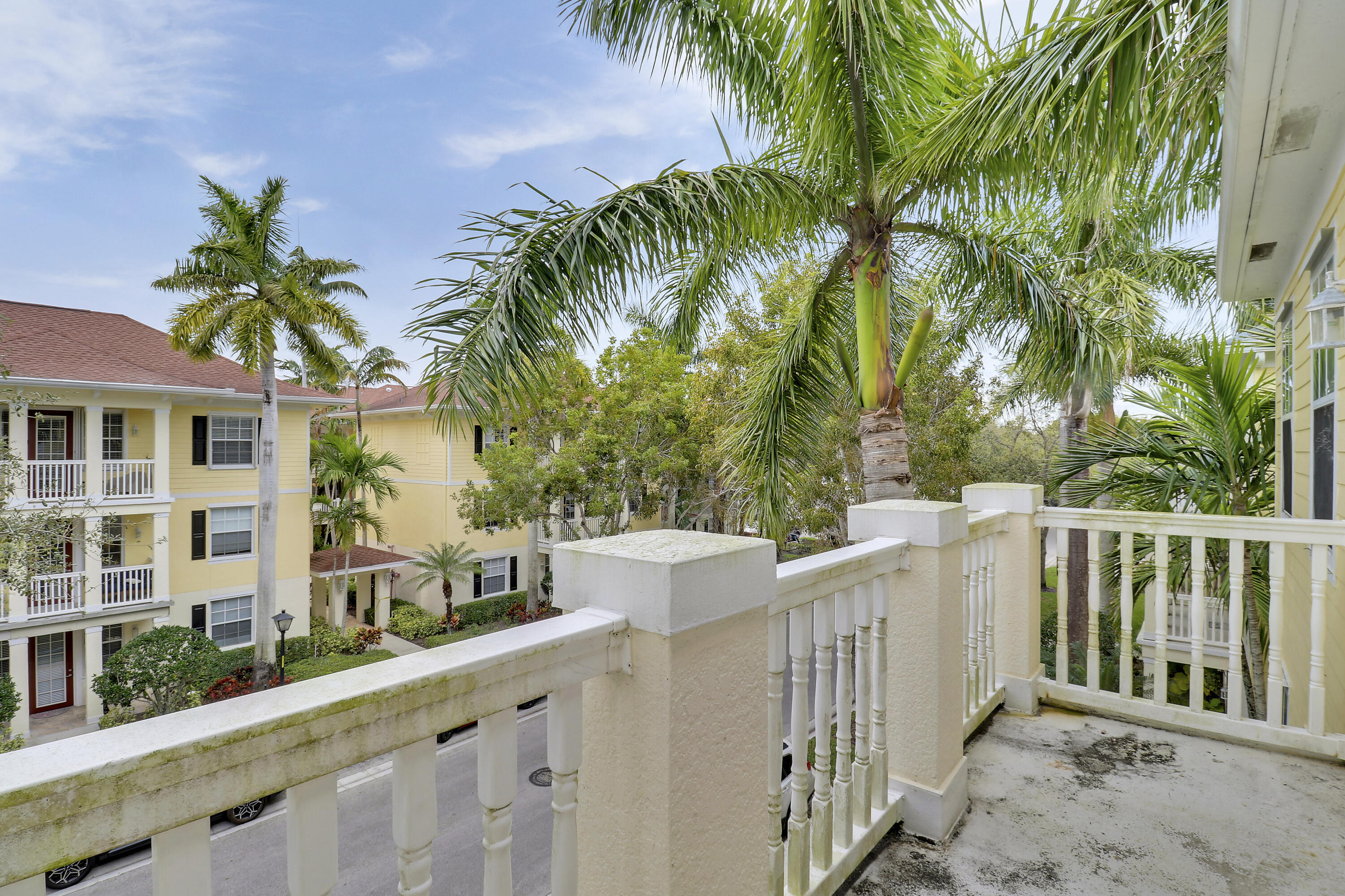 225 Murcia Drive, Unit 307 Jupiter, FL 33458 - Photo 32 of 36 a view of a house with a swimming pool and wooden fence