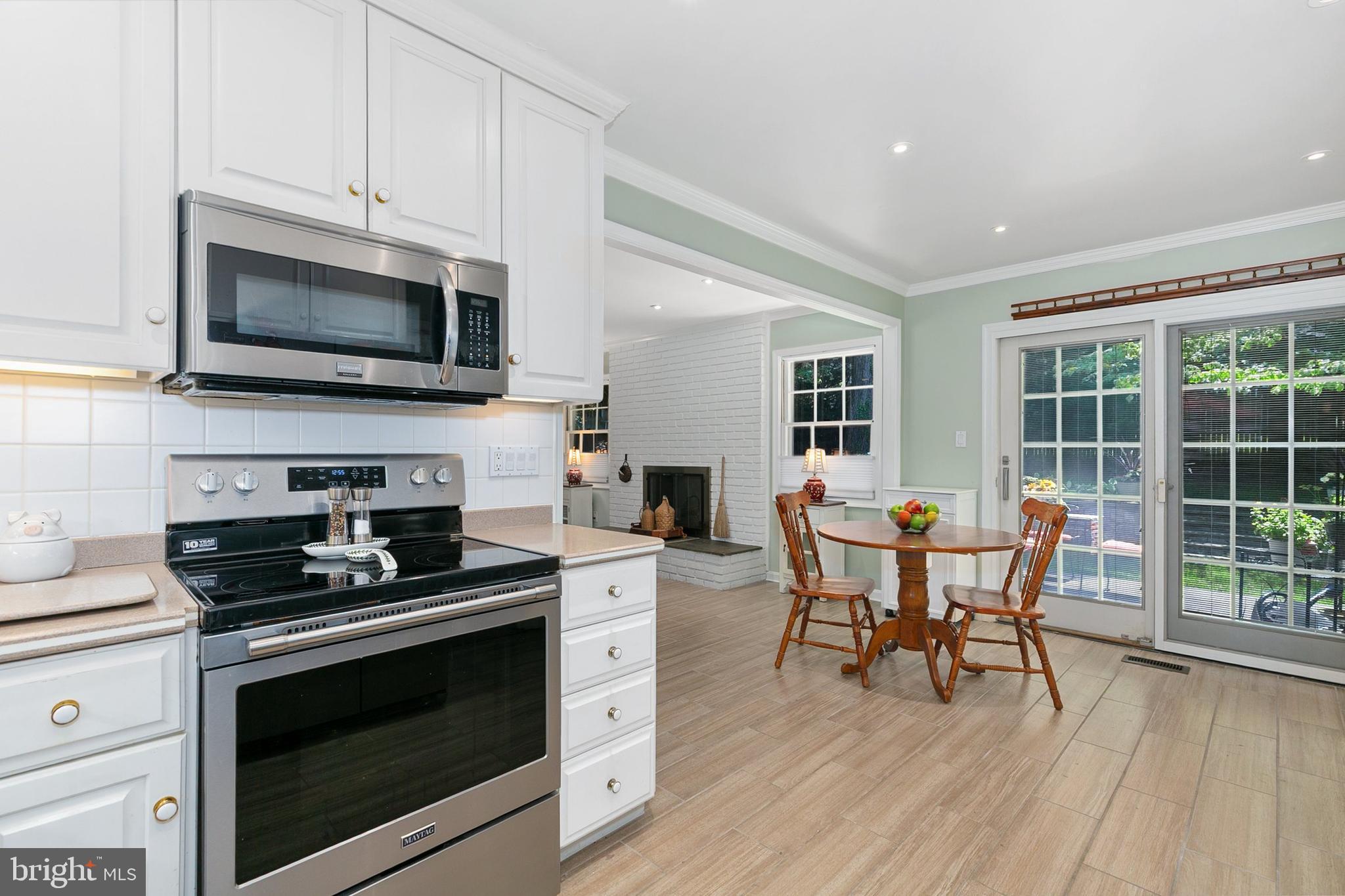3004 Bluff Point Lane Silver Spring, MD 20906 - Photo 19 of 74 a kitchen with a stove a microwave and cabinets