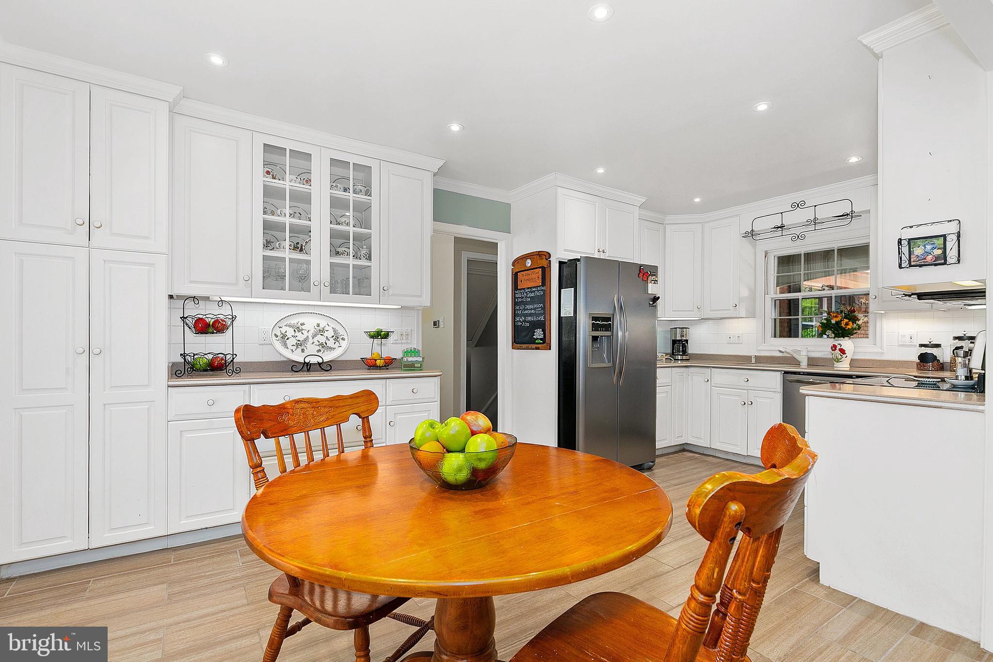 3004 Bluff Point Lane Silver Spring, MD 20906 - Photo 21 of 74 a kitchen with stainless steel appliances granite countertop a dining table and chairs