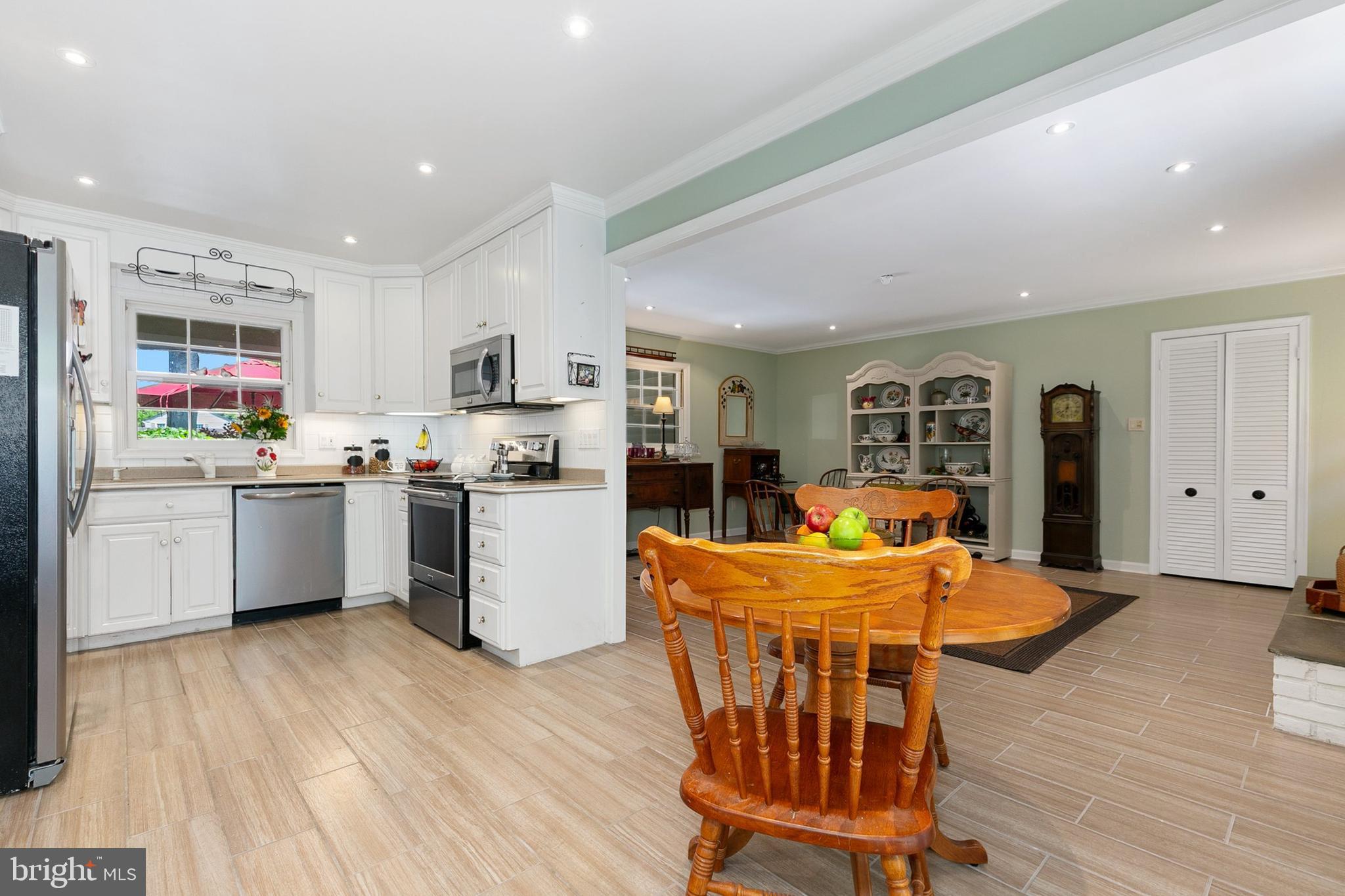 3004 Bluff Point Lane Silver Spring, MD 20906 - Photo 22 of 74 a kitchen with stainless steel appliances granite countertop a refrigerator a stove top oven a sink dishwasher and white cabinets with wooden floor