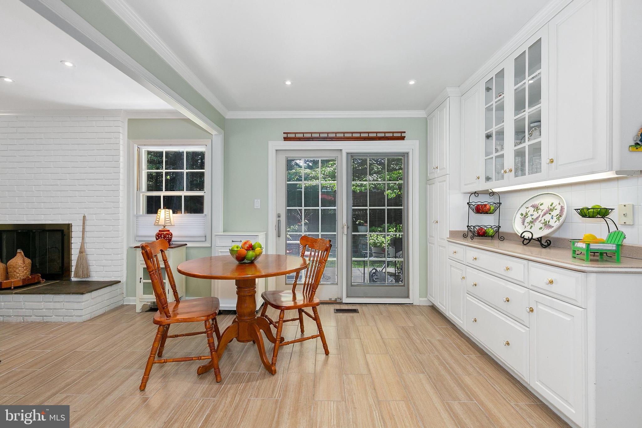 3004 Bluff Point Lane Silver Spring, MD 20906 - Photo 24 of 74 a dining room with furniture a fireplace and wooden floor