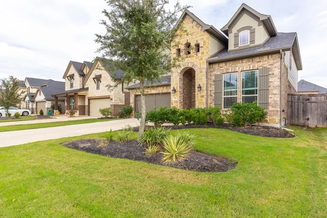 a view of a house with a swimming pool and a yard