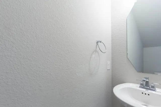 a bathroom with a sink and mirror