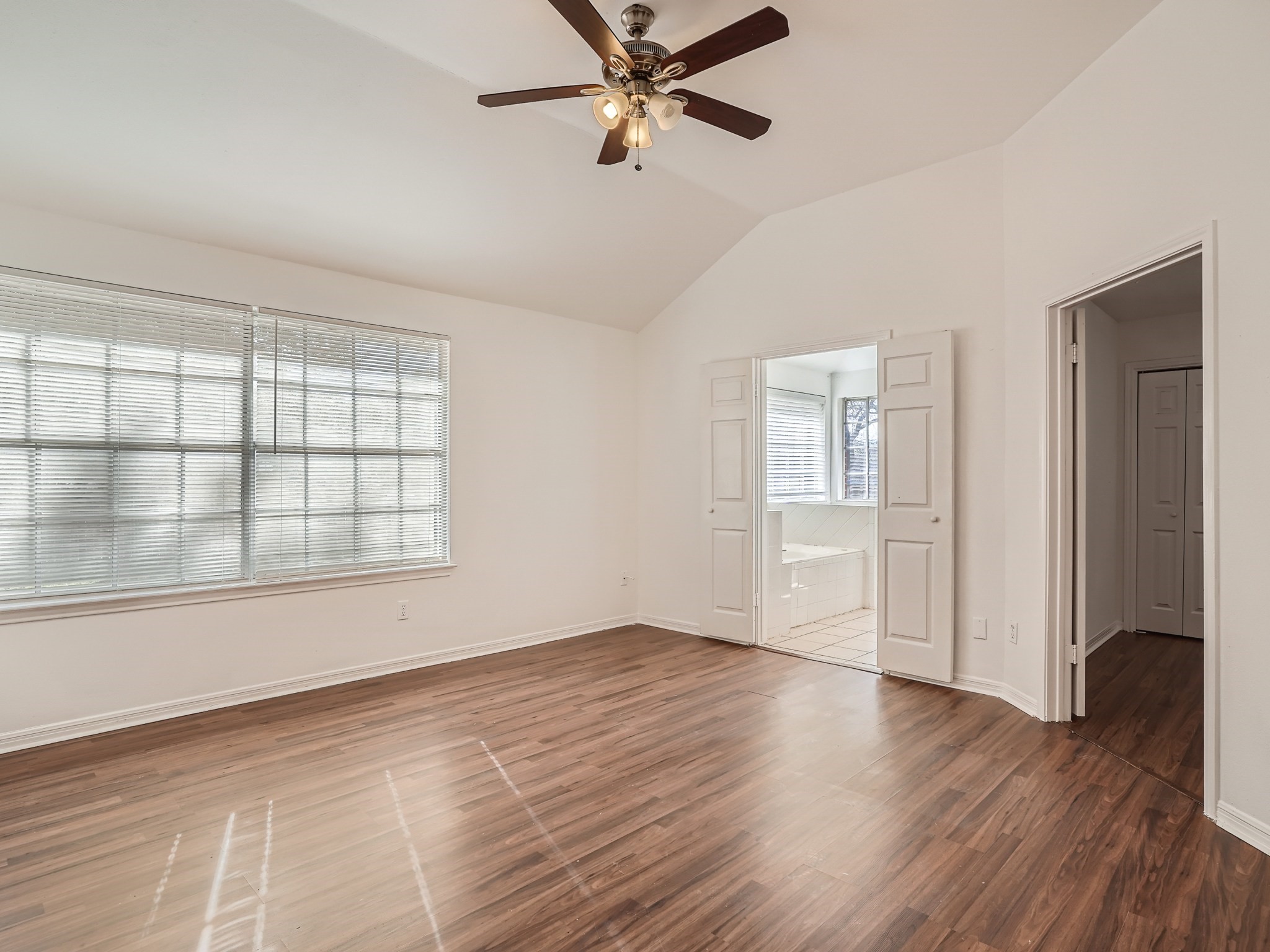 811 Canyon Bend Road Pflugerville, TX 78660 - Photo 5 of 11 wooden floor in an empty room with a window