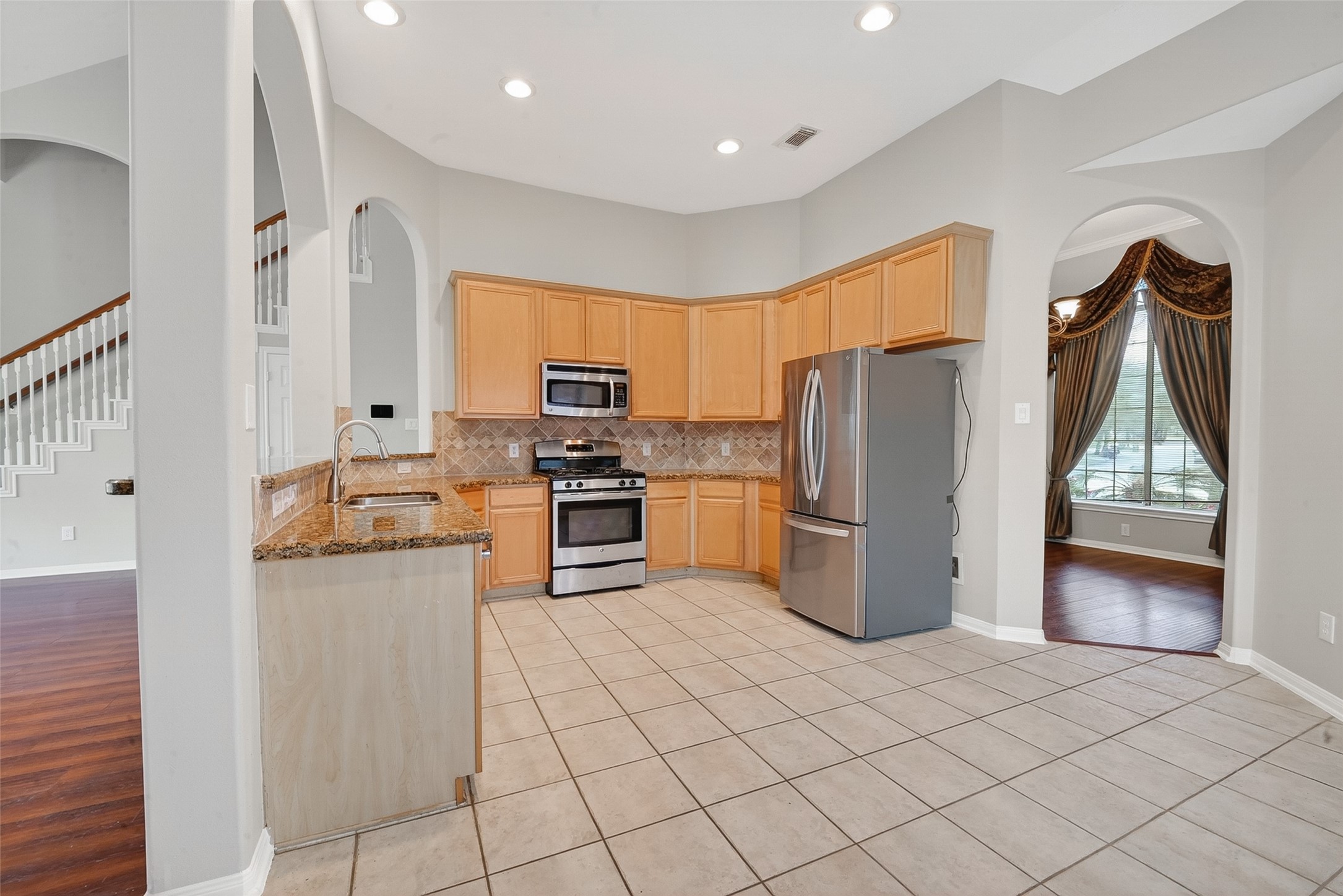 14308 Rocky Briar Lane Rosharon, TX 77583 - Photo 11 of 46 a kitchen with granite countertop a refrigerator a stove a sink and dishwasher