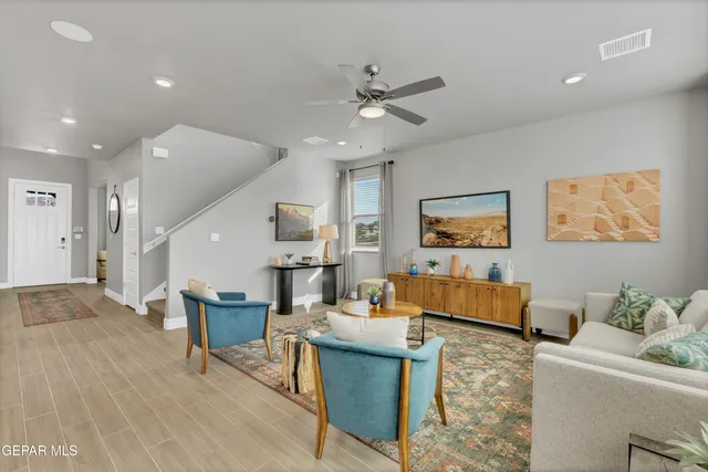 a living room with furniture and a wooden floor