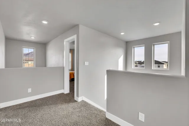 a living room with furniture and large windows