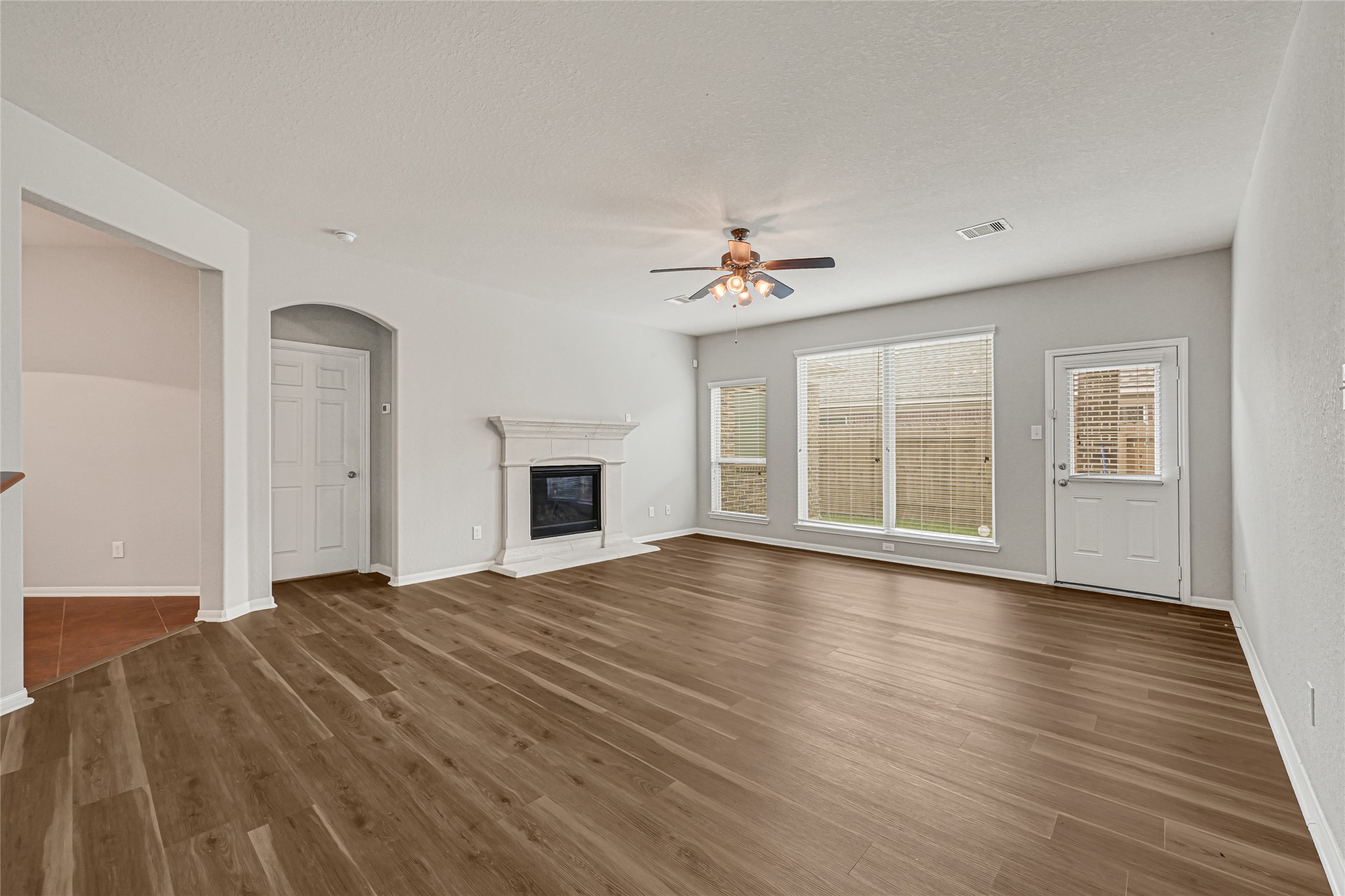 5331 Seabird Street Baytown, TX 77521 - Photo 13 of 38 a view of empty room with wooden floor and fireplace