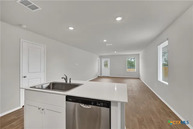 a kitchen with a sink and cabinets