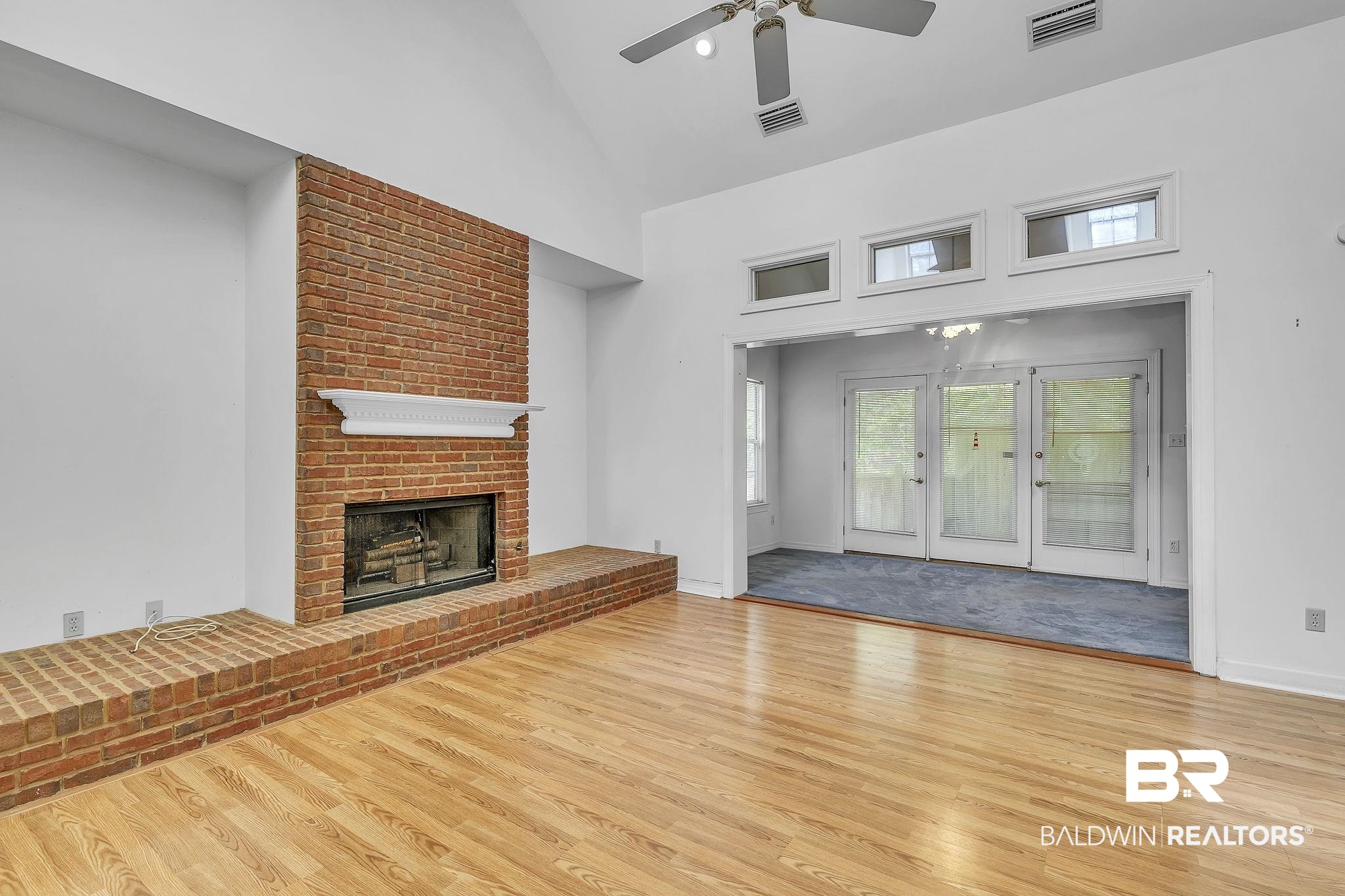 367 Ridgewood Drive Daphne, AL 36526 - Photo 20 of 71 Unfurnished living room with visible vents, high vaulted ceiling, wood finished floors, and a ceiling fan