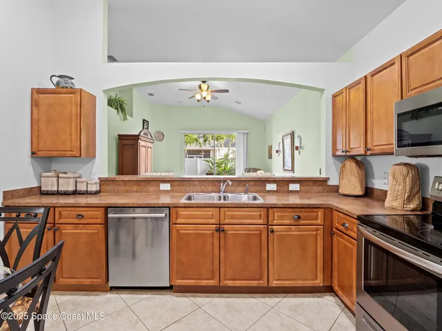 a kitchen with a sink stove top oven and microwave