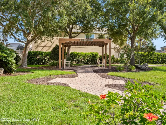 a view of a house with garden and trees