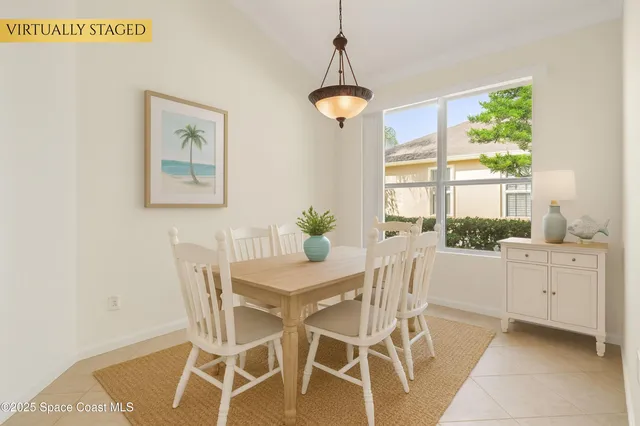 a dining room with furniture a chandelier and window