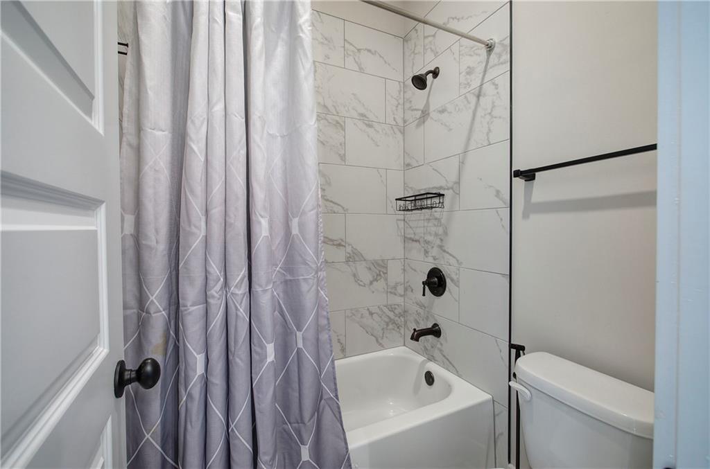 503 London Road Ball Ground, GA 30107 - Photo 32 of 55 a bathroom with a bathtub a shower a toilet and sink
