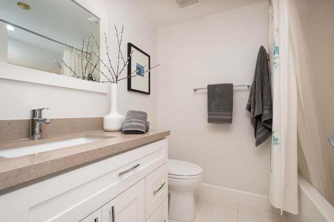 616 Ansel Road, Unit 5 Burlingame, CA 94010 - Photo 15 of 20 a bathroom with a granite countertop sink a toilet and shower