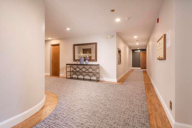 616 Ansel Road, Unit 5 Burlingame, CA 94010 - Photo 16 of 20 a view of a hallway with a couch and chandelier