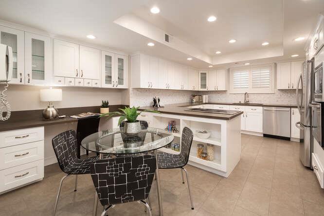 616 Ansel Road, Unit 5 Burlingame, CA 94010 - Photo 4 of 20 a kitchen with stainless steel appliances granite countertop a table chairs sink and cabinets
