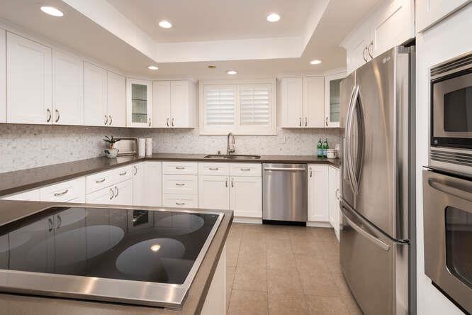 616 Ansel Road, Unit 5 Burlingame, CA 94010 - Photo 6 of 20 a kitchen with a sink a refrigerator and cabinets