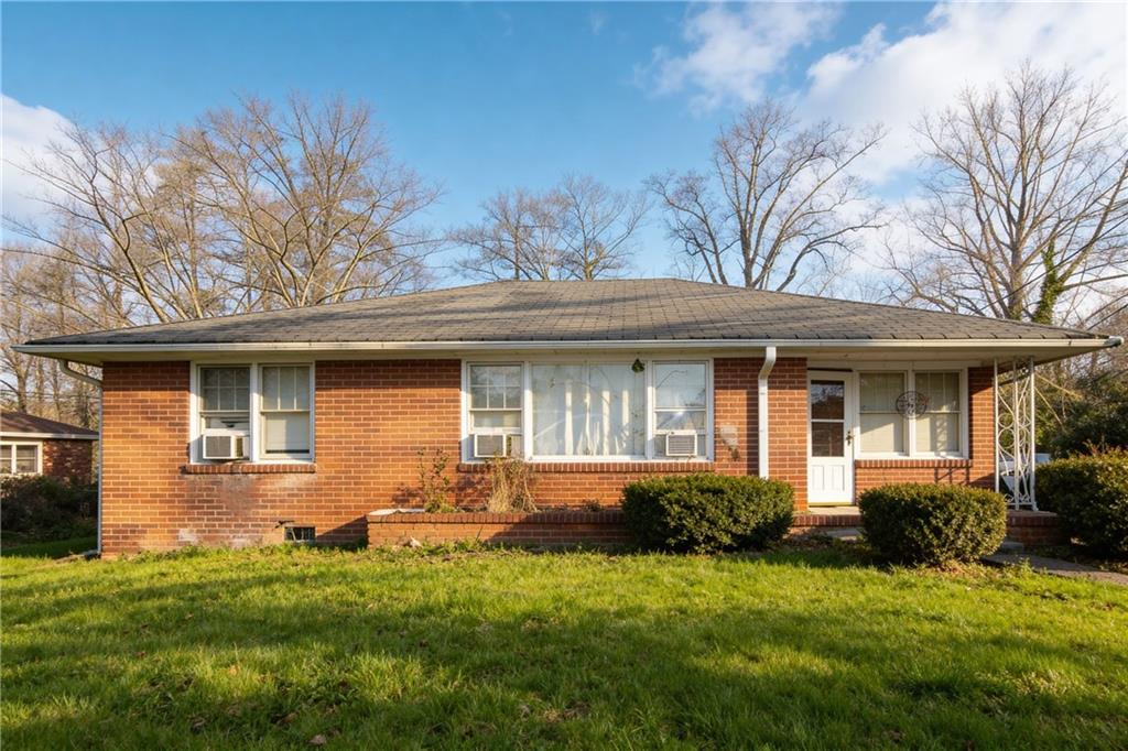 154 Privette Road Southwest Marietta, GA 30008 - Photo 1 of 28 a front view of a house with a garden